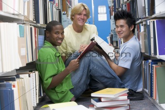 Group of university students working in library