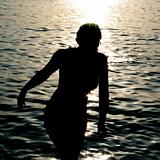 Silhouette of a woman getting out of the ocean