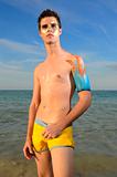 young male model on the beach