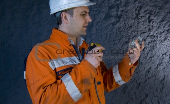 Engineer inspecting mineral