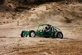 Speeding dune buggy in sand dunes