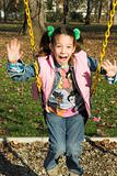 child swinging at the playground