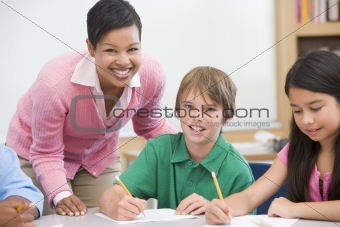 Teacher and pupil in elementary school classroom