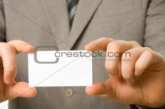 Blank business card in the hands of a businessman