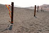 Fence in volcanic sand