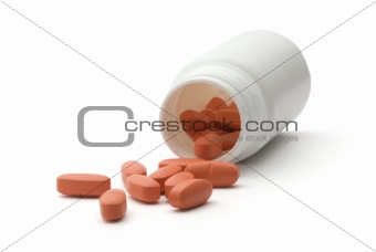 Orange vitamin pills with dose on white background