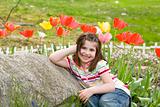 Girl Smiling in Front of Flowe
