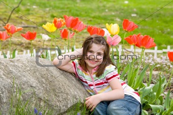 Girl Smiling in Front of Flowe