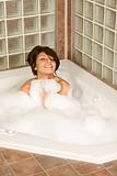 Female relaxing in foam bath