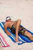 Man Lying on Blue Beach Towel