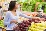 Young woman shopping in produce section 