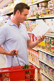 Man checking food labelling in supermarket
