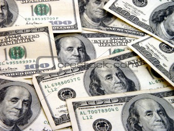 $100 Bills spread out in random display