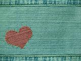 Background the heart attached by threads to jeans
