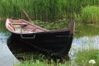 Old wooden boat at riverbank