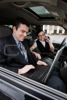 Businessman and Businesswoman in a Car