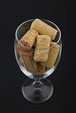 wineglass filled with corks