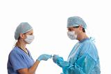Scrub nurse handing surgeon forceps