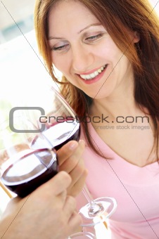 Mature woman toasting with red wine