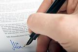 Signing letter with a pen 