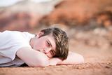 male teenager laying on ground