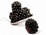 High key blackberries with spoon isolated on white