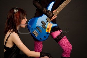Rock girl licking bass guitar