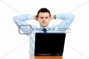 Thoughtful businessman sitting behind the computer