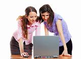 two young attractive women working with the computer