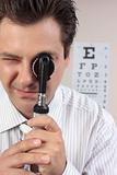 Eye doctor using opthalmoscope