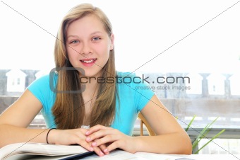 Happy teenage girl studying