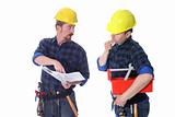 Two construction workers with architectural plans 