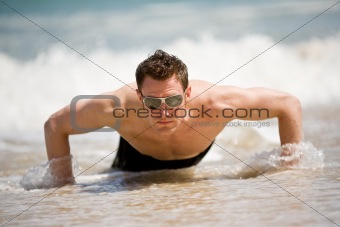 guy getting up from the beach