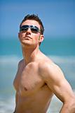 caucasian hunk at the beach with shades