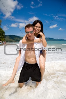 playful couple at the beach 