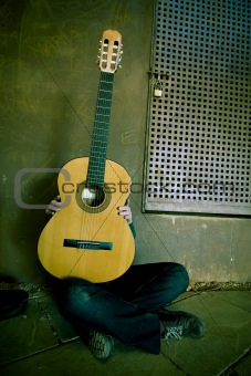 Young person behind classic guitar