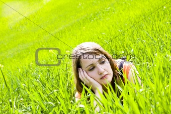 Young pensive on the grass