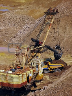 excavator and dump truck in quarry