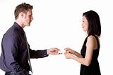 businessman exchanging name cards with woman