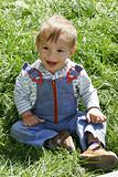 happy baby boy in green grass