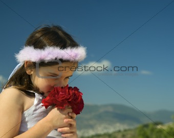 girl smelling red roses