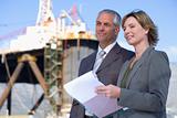 Two business people on oil rig
