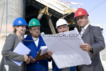 Engineers and business people on oil rig
