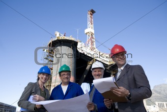 Engineers and business people on oil rig