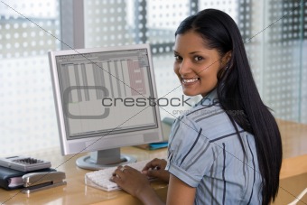 Female business person in front of computer