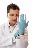 Doctor or scientist putting on nitrile safety gloves