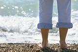 close up of female feet on pebble beach