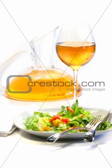 Plate of salad and wine glass