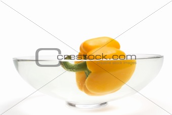 Yellow paprika floating in vase with water