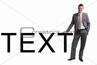 young businessman standing, leaning against text